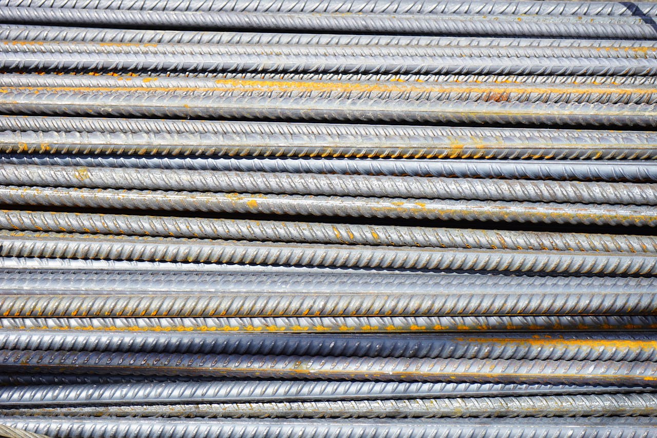 services-02 Close-up of stacked rusty steel reinforcing bars used in construction.