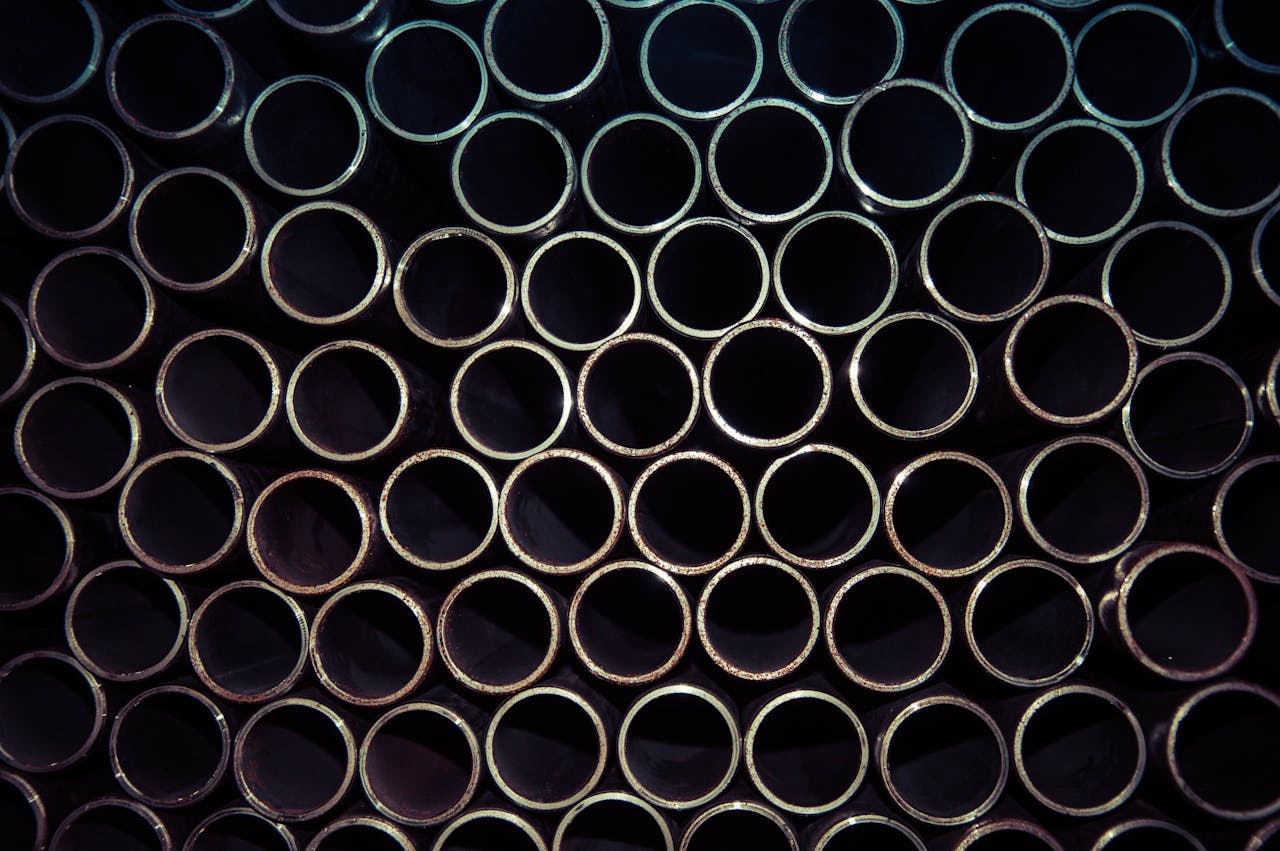 services-01 A detailed macro shot of stacked metal tubes forming a circular pattern, highlighting industrial design.